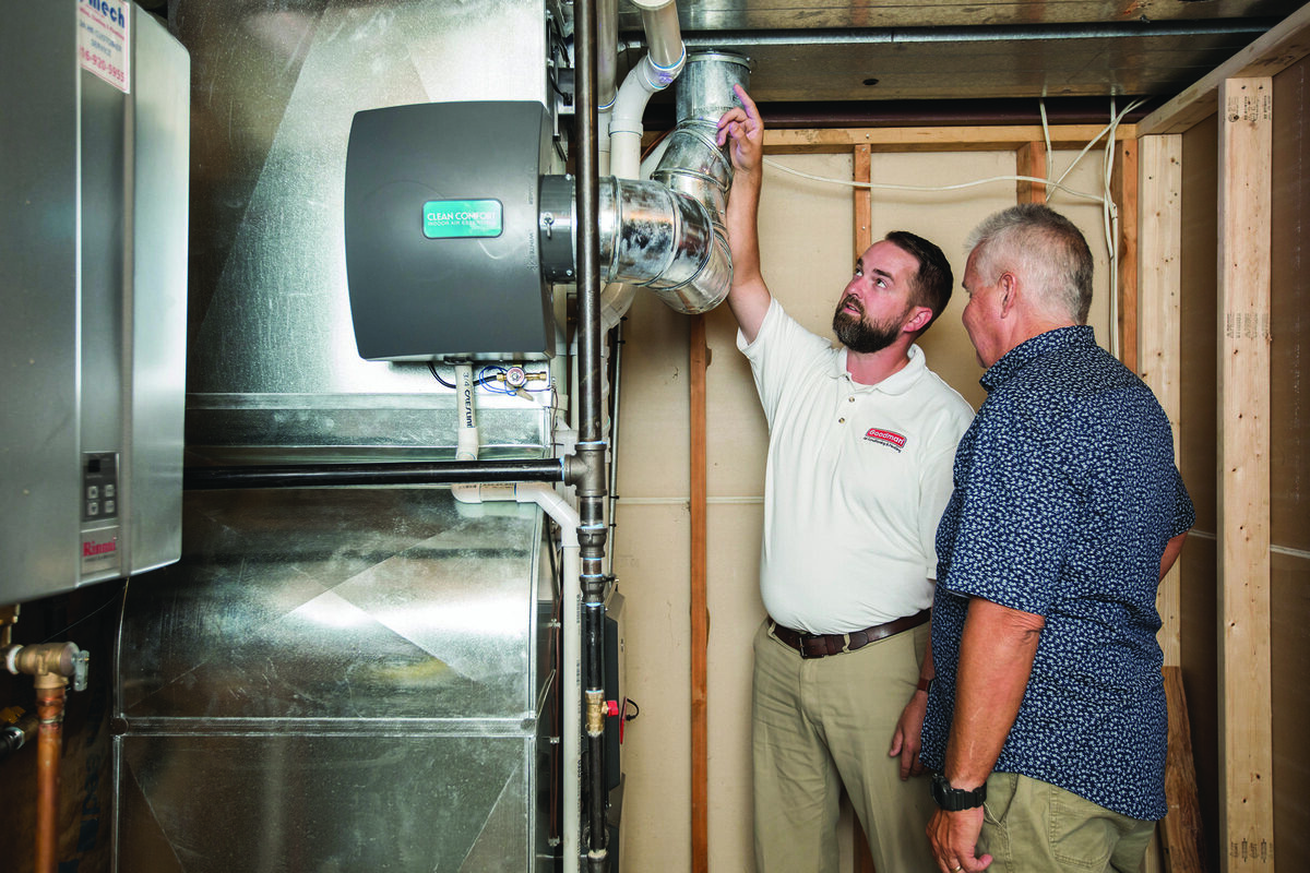 HVAC technician explaining a furnace installation to a homeowner